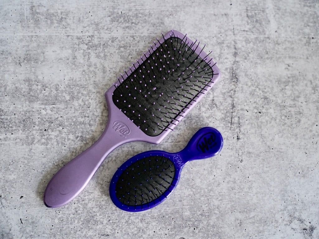 purple rectangle bigger wet hair brush and smaller royal blue oval travel wet brush