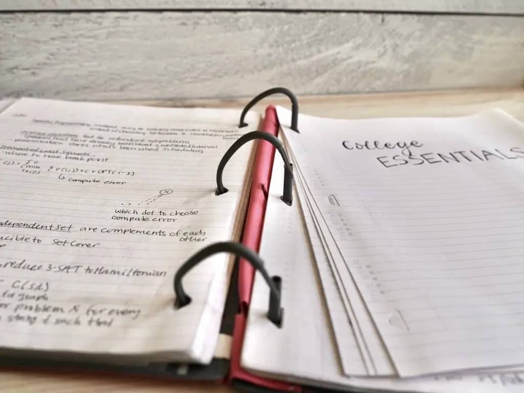 pink fivestar notebook binder with reinforced paper inside with notes written