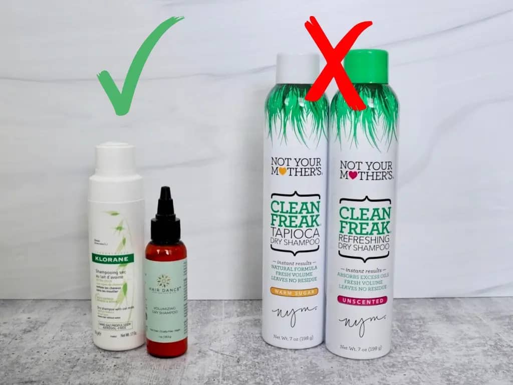 two dry shampoo powders klorane and hair dance next to two not your mother's dry shampoo aerosol spray cans