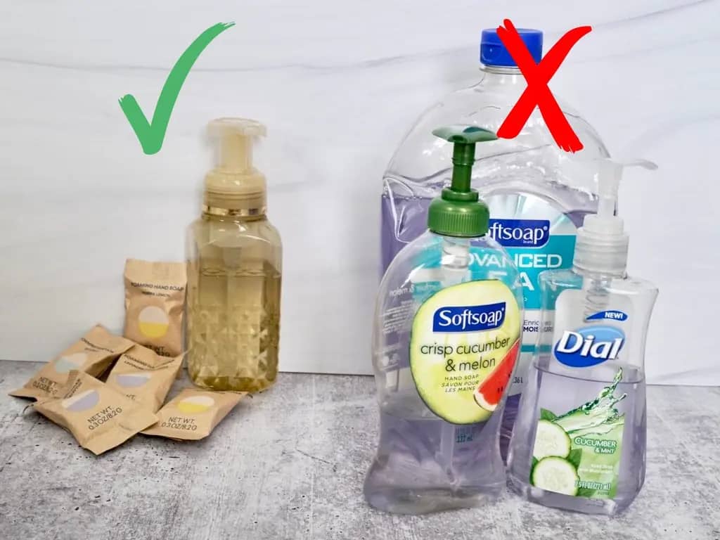 blueland hand soap refill tablets and foam soap dispenser bottle next to big plastic bottles of hand soap