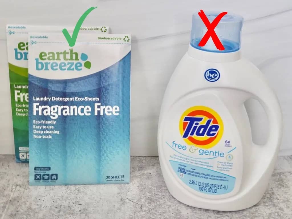 two earth breeze laundry detergent sheets fragrance free and fresh scent next to a bottle of tide free and gentle laundry detergent